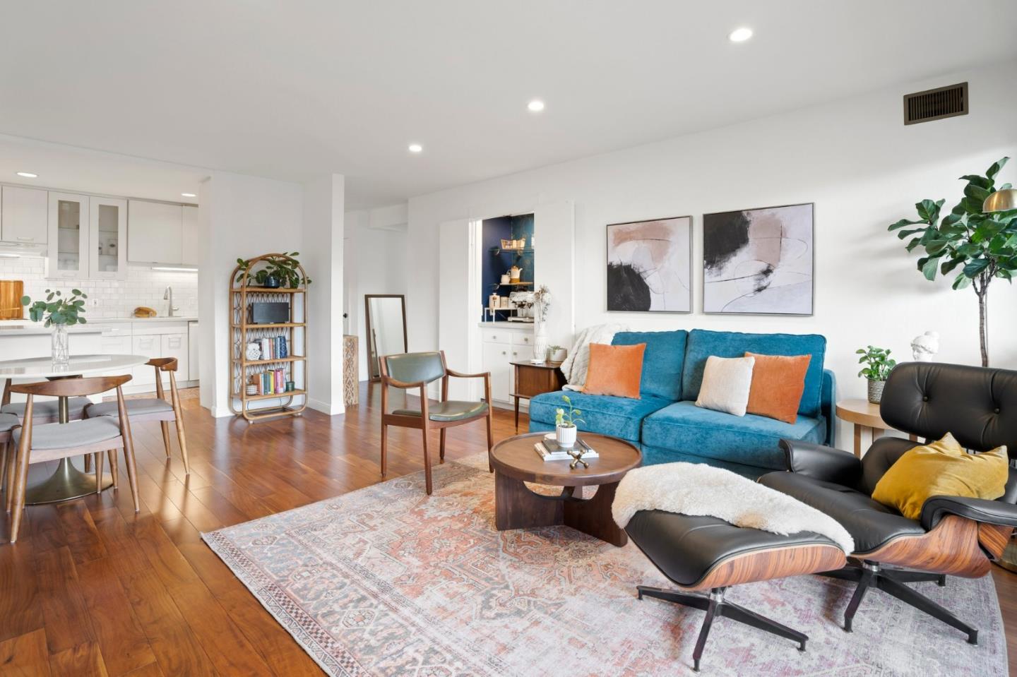 a living room with furniture and wooden floor