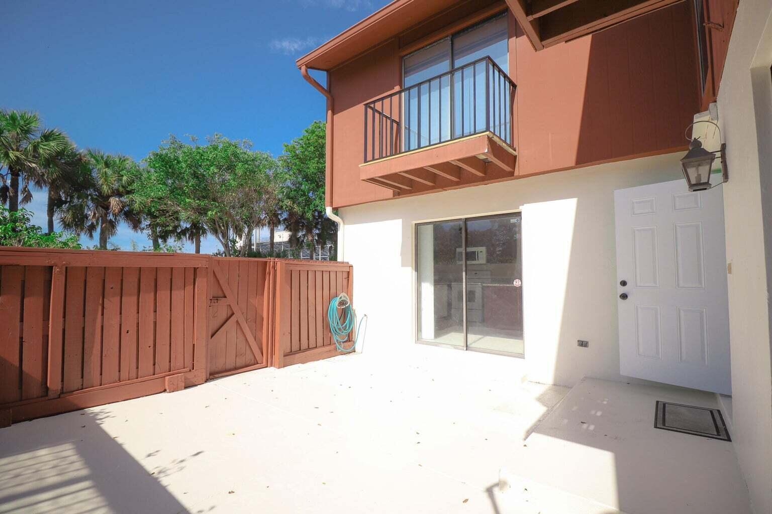 a backyard of a house with wooden fence