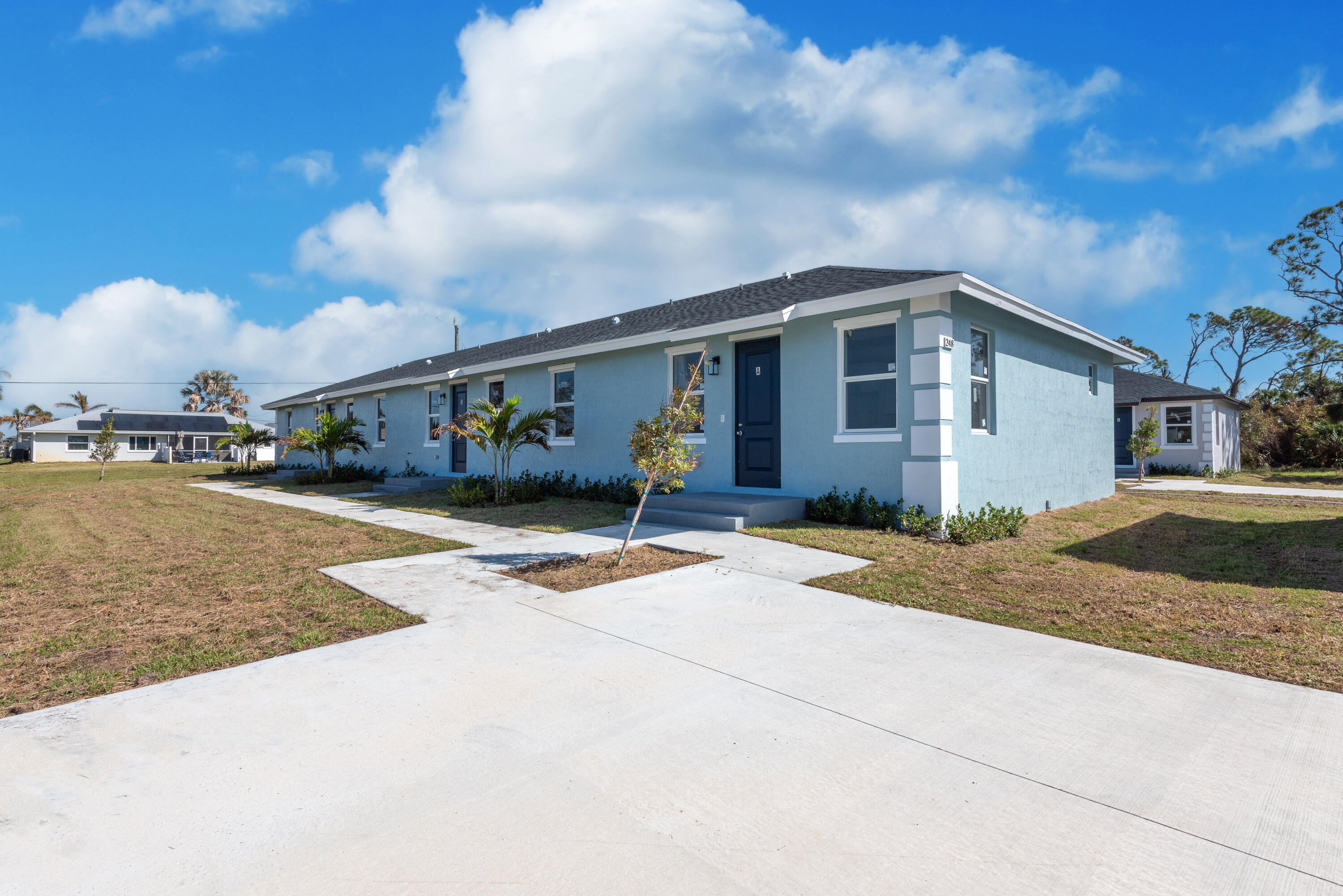 a front view of house with yard and car parked