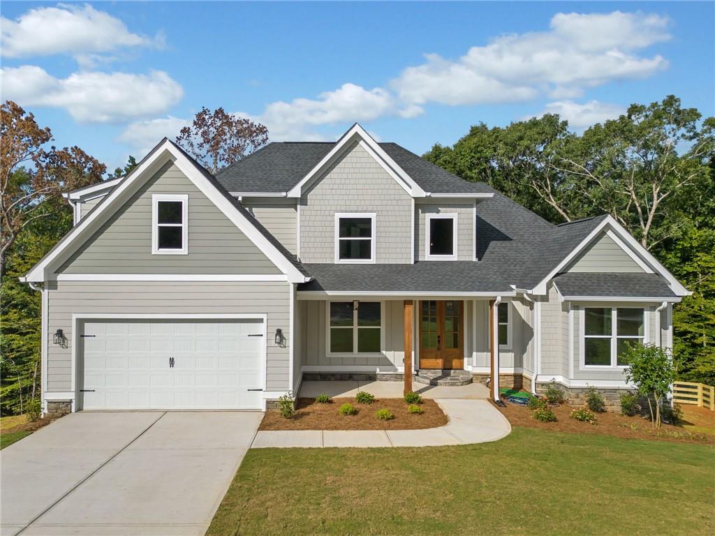 a front view of a house with outdoor seating yard and porch