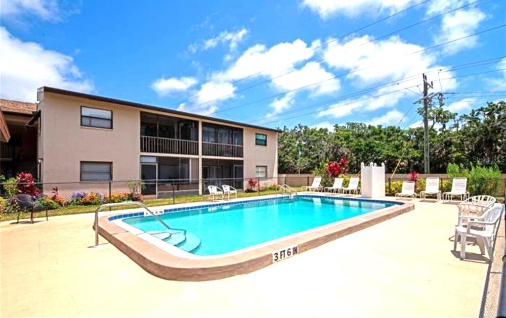 a view of a swimming pool with a lounge chairs