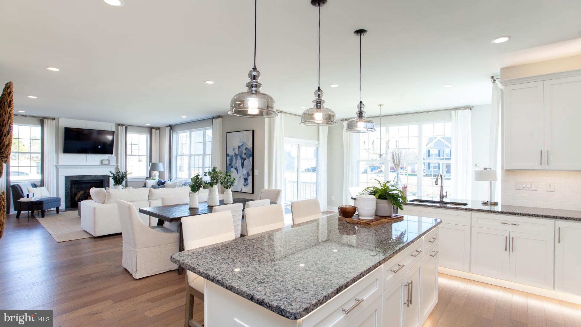 a kitchen with sink cabinets and living room view