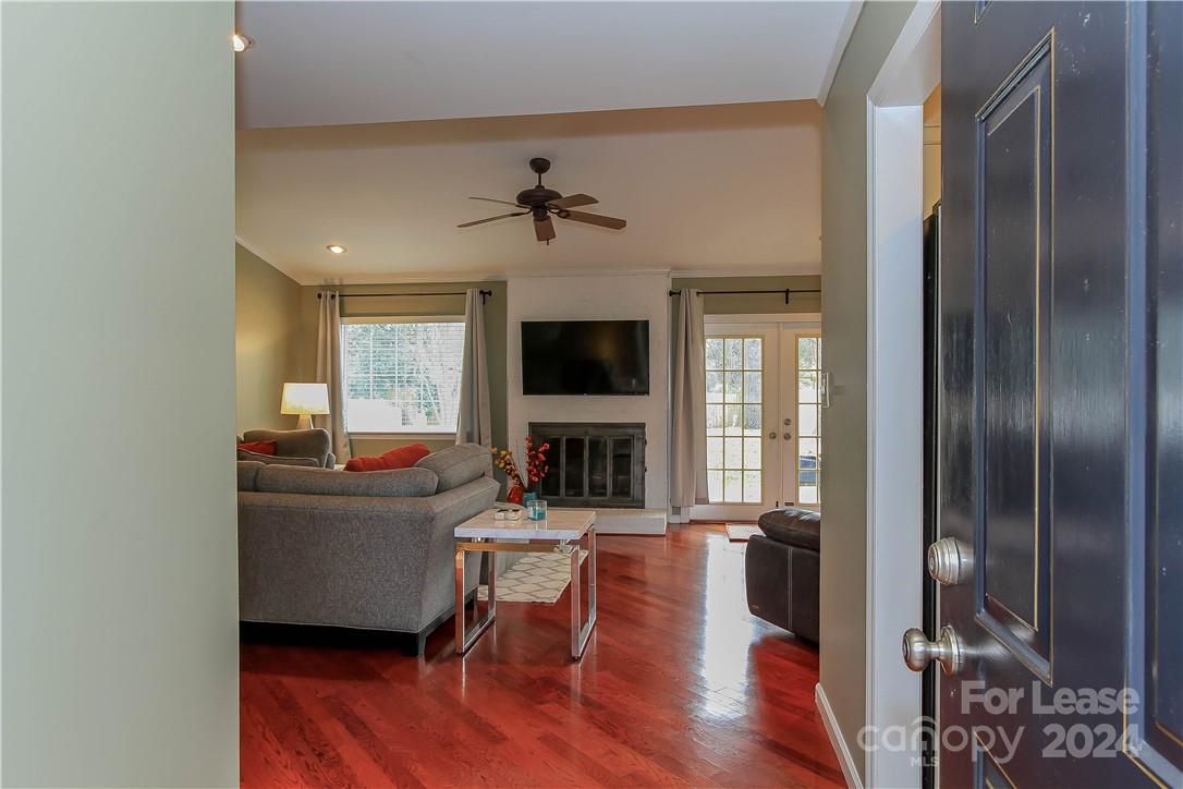 a living room with furniture a fireplace and a flat screen tv