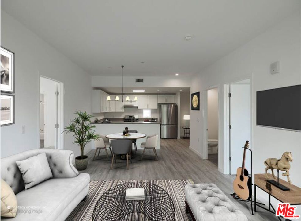 a living room with furniture wooden floor and a flat screen tv