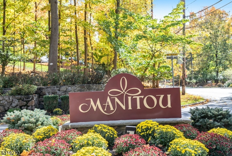 a sign broad in front of flowers