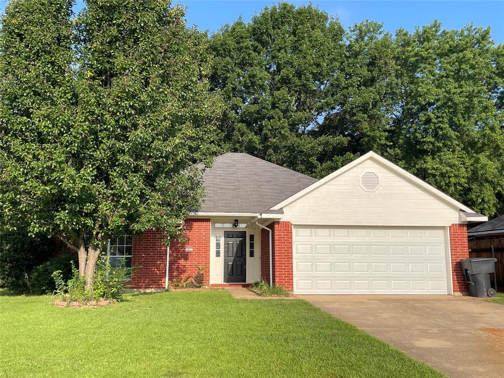 a view of a house with a yard and tree s