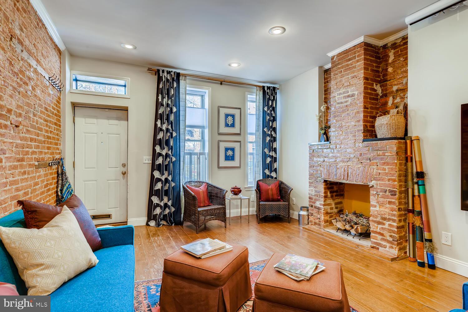 a living room with furniture fireplace and a large window