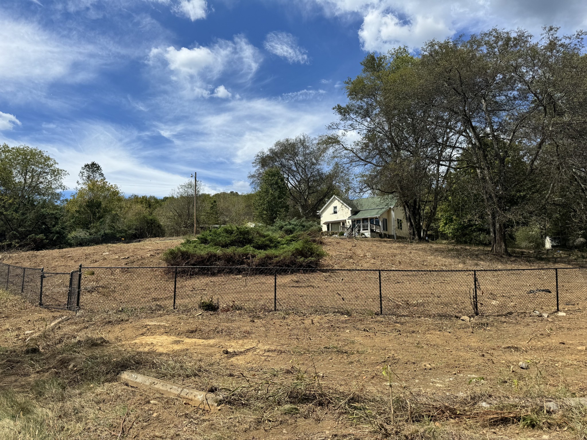 a view of a yard with wooden fence