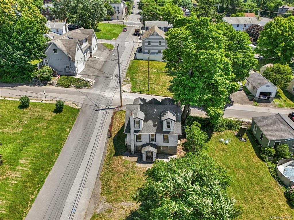 an aerial view of a house with swimming pool and garden view