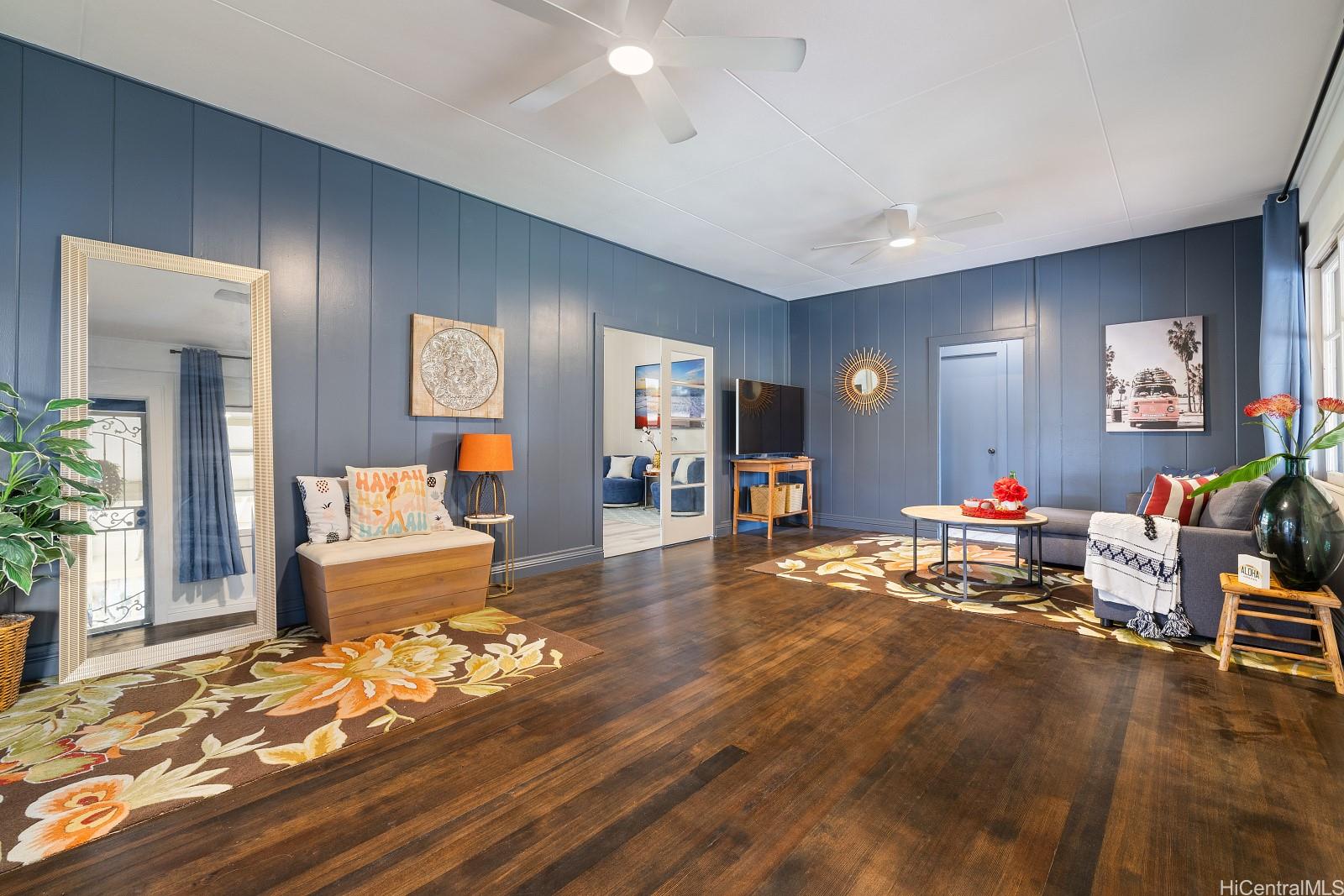 a living room with furniture and a wooden floor