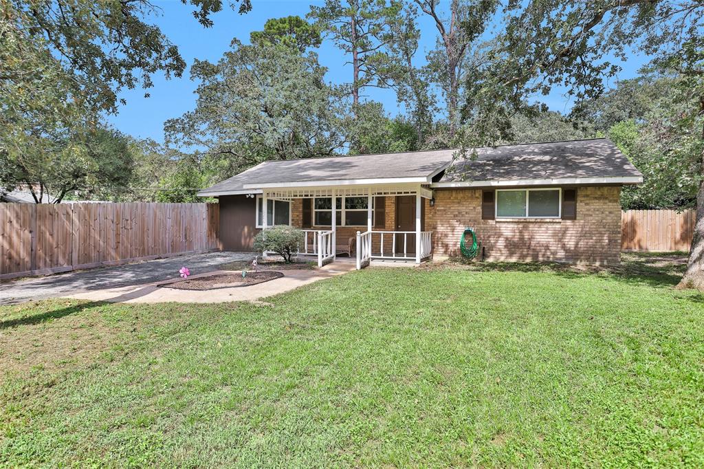 a view of a house with a yard patio and a garden