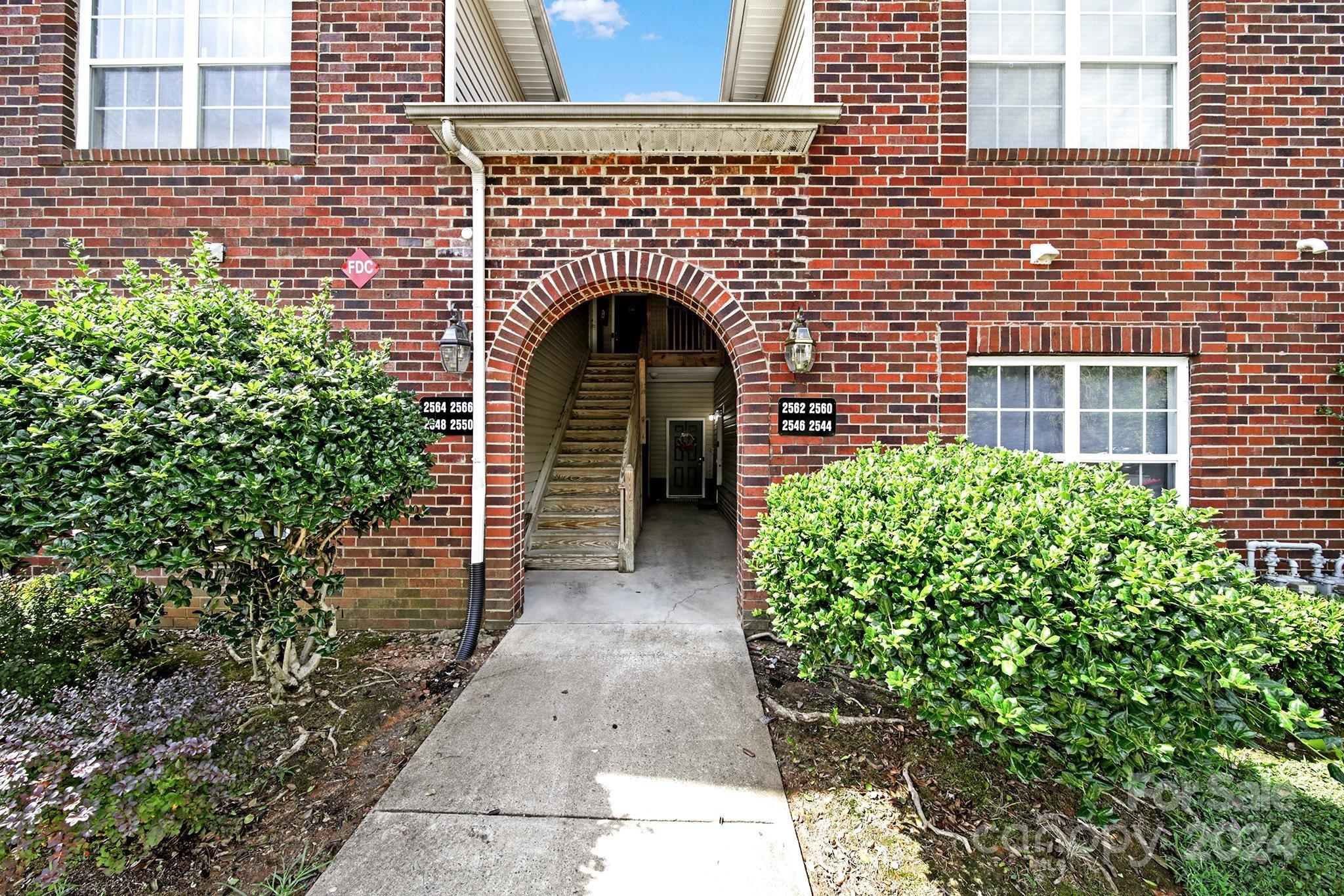 a view of front door of house with green space