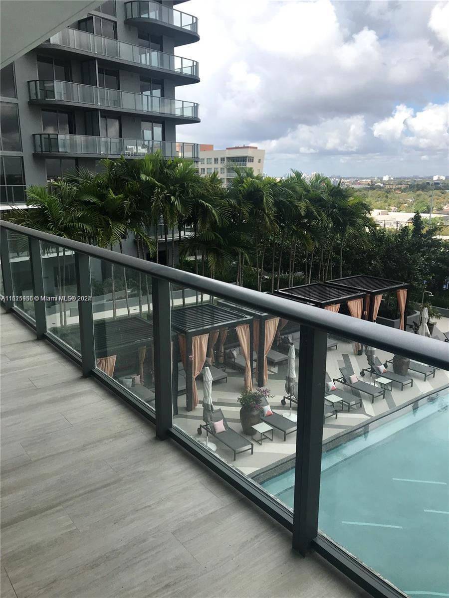 a view of a balcony with wooden floor and city view