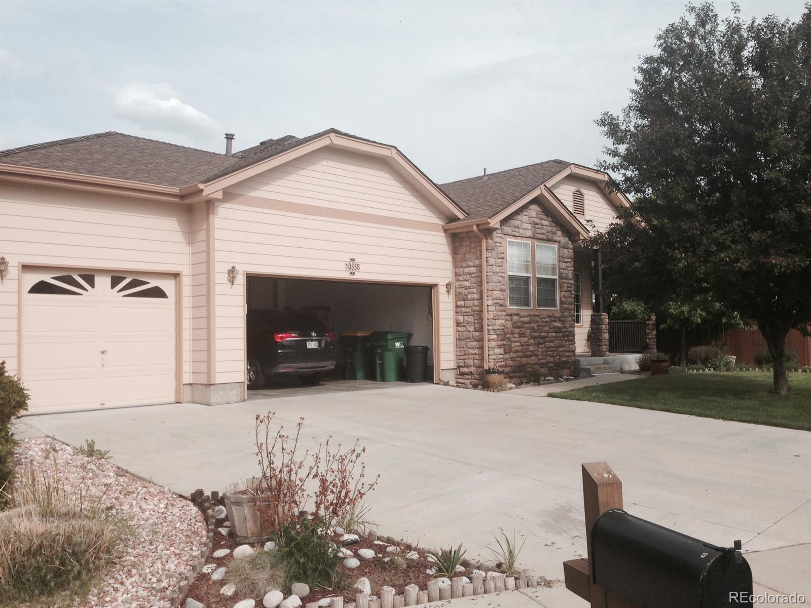 a front view of a house with a yard and garage