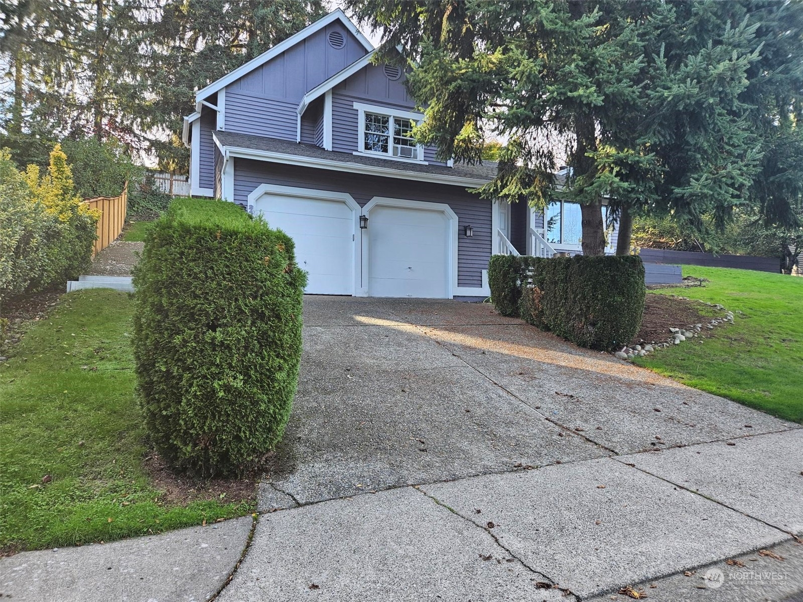 a front view of a house with a garden