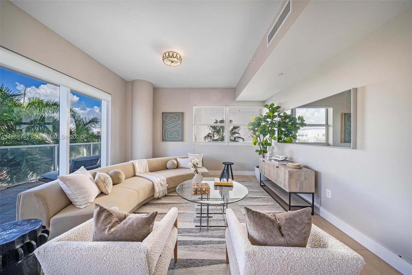 a living room with furniture and a large window