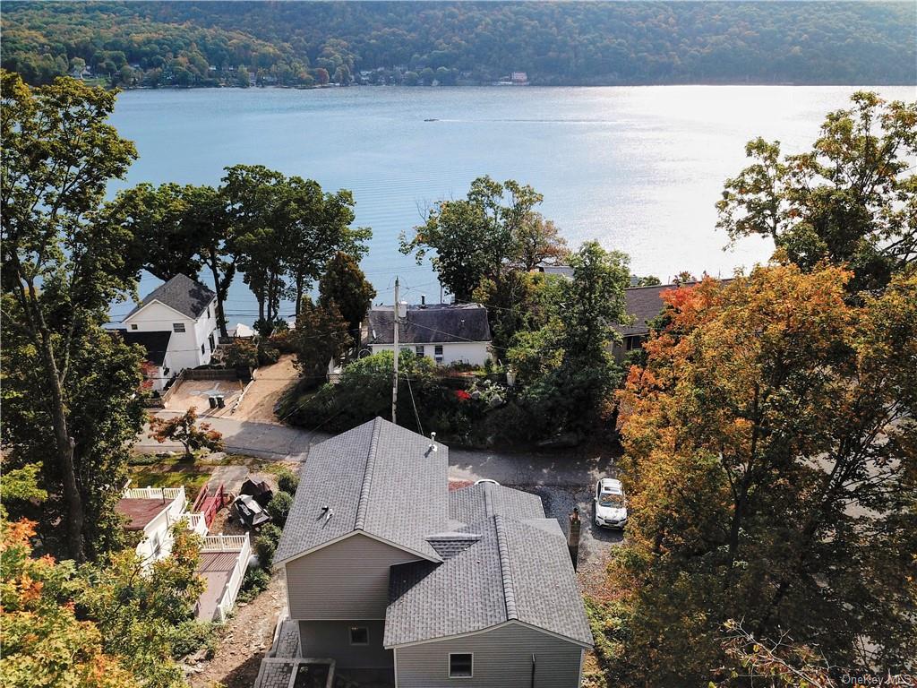 a terrace with outdoor seating and lake view