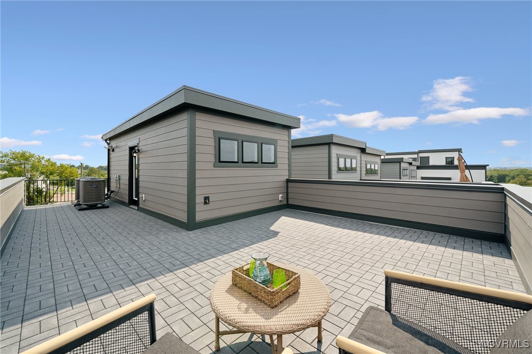 a backyard of a house with table and chairs