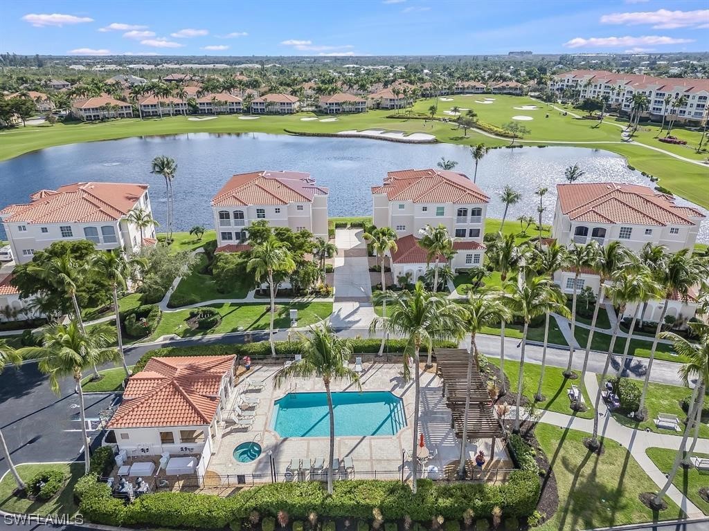 an aerial view of residential houses with outdoor space and river