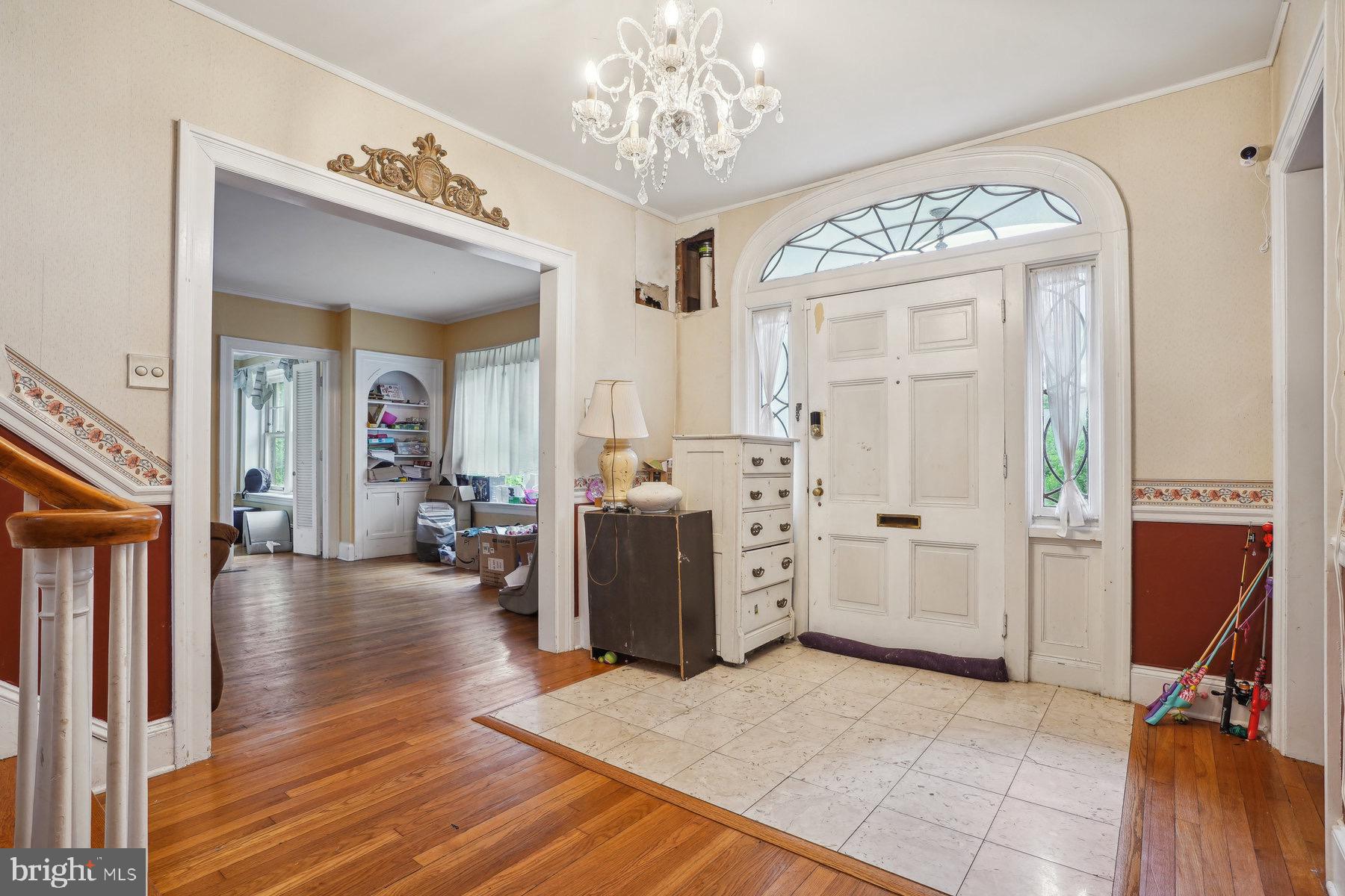 a view of a hallway with wooden floor and windows