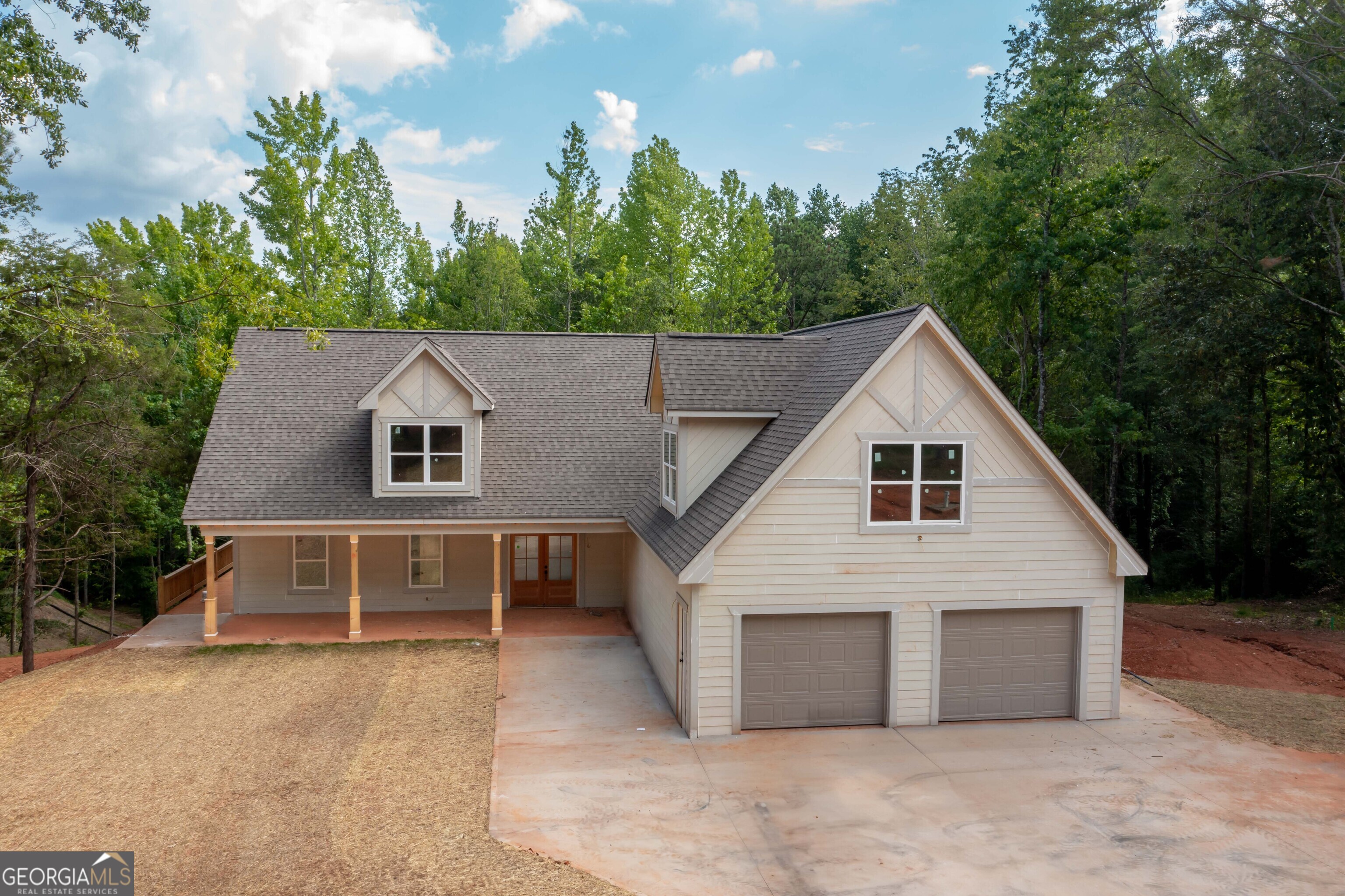 a view of a house with a yard and garage