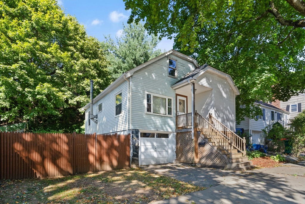 a view of a house with a tree beside it