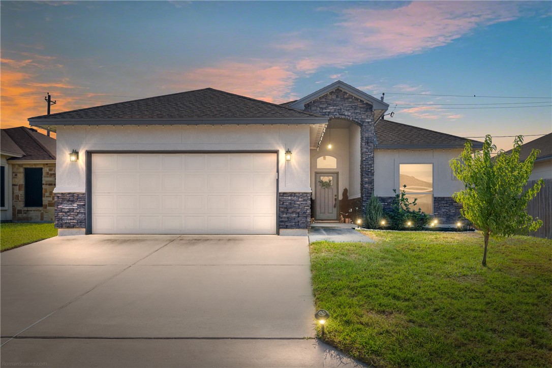 a view of a house with a yard and garage