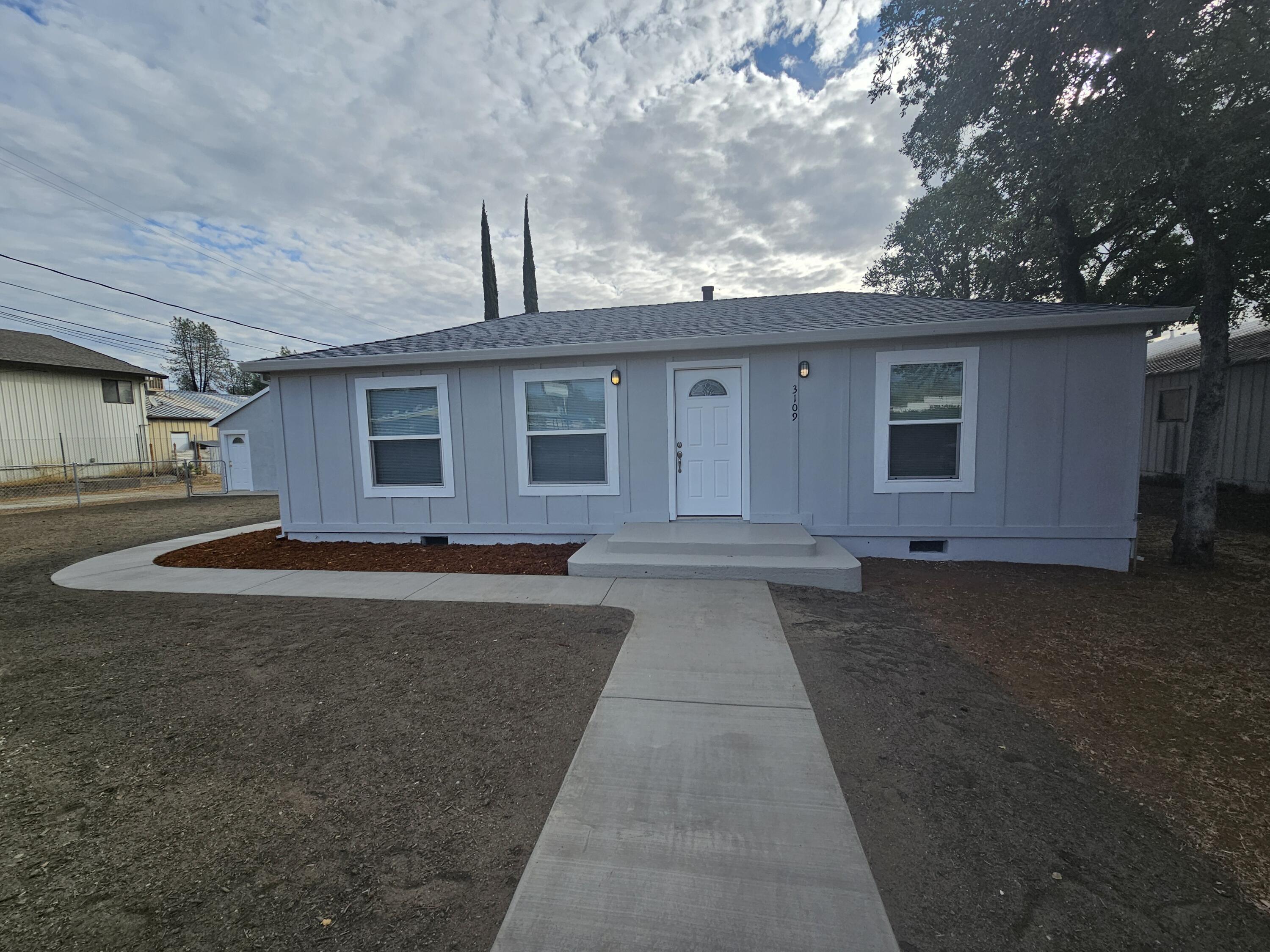 a front view of a house with yard