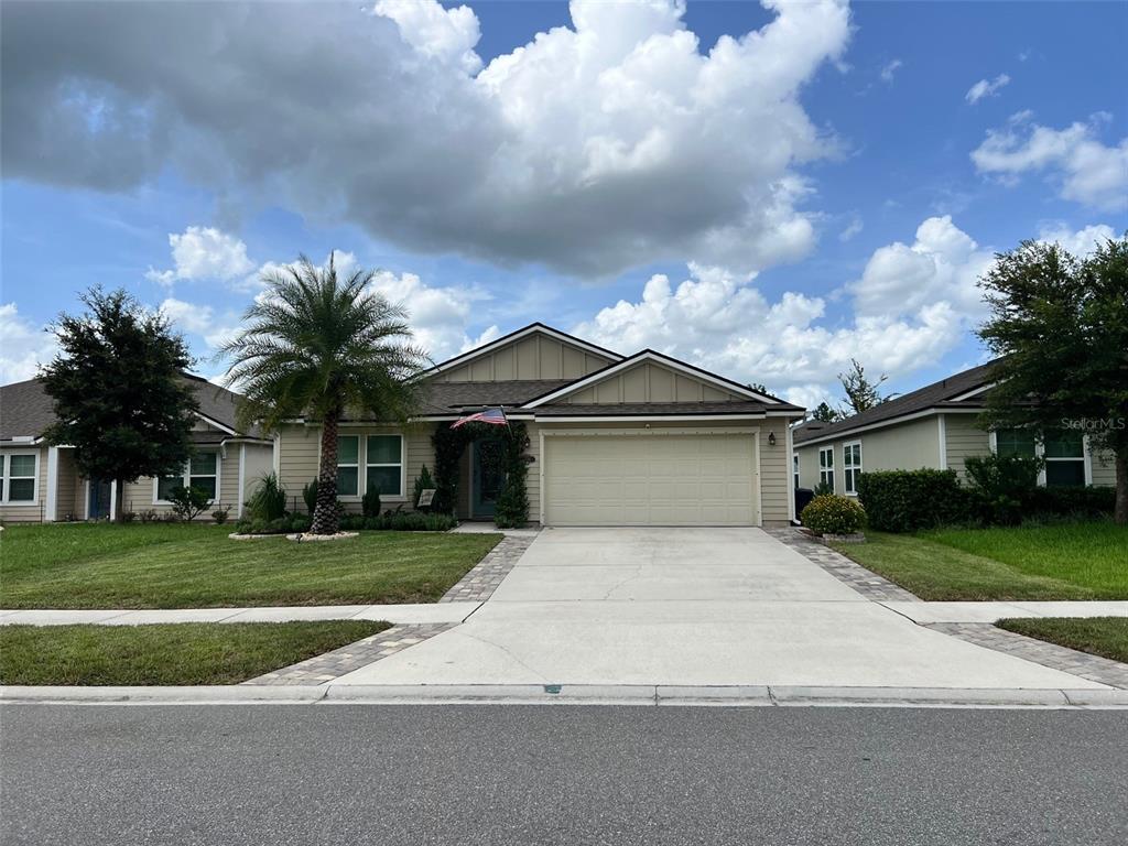 a front view of a house with a yard and garage