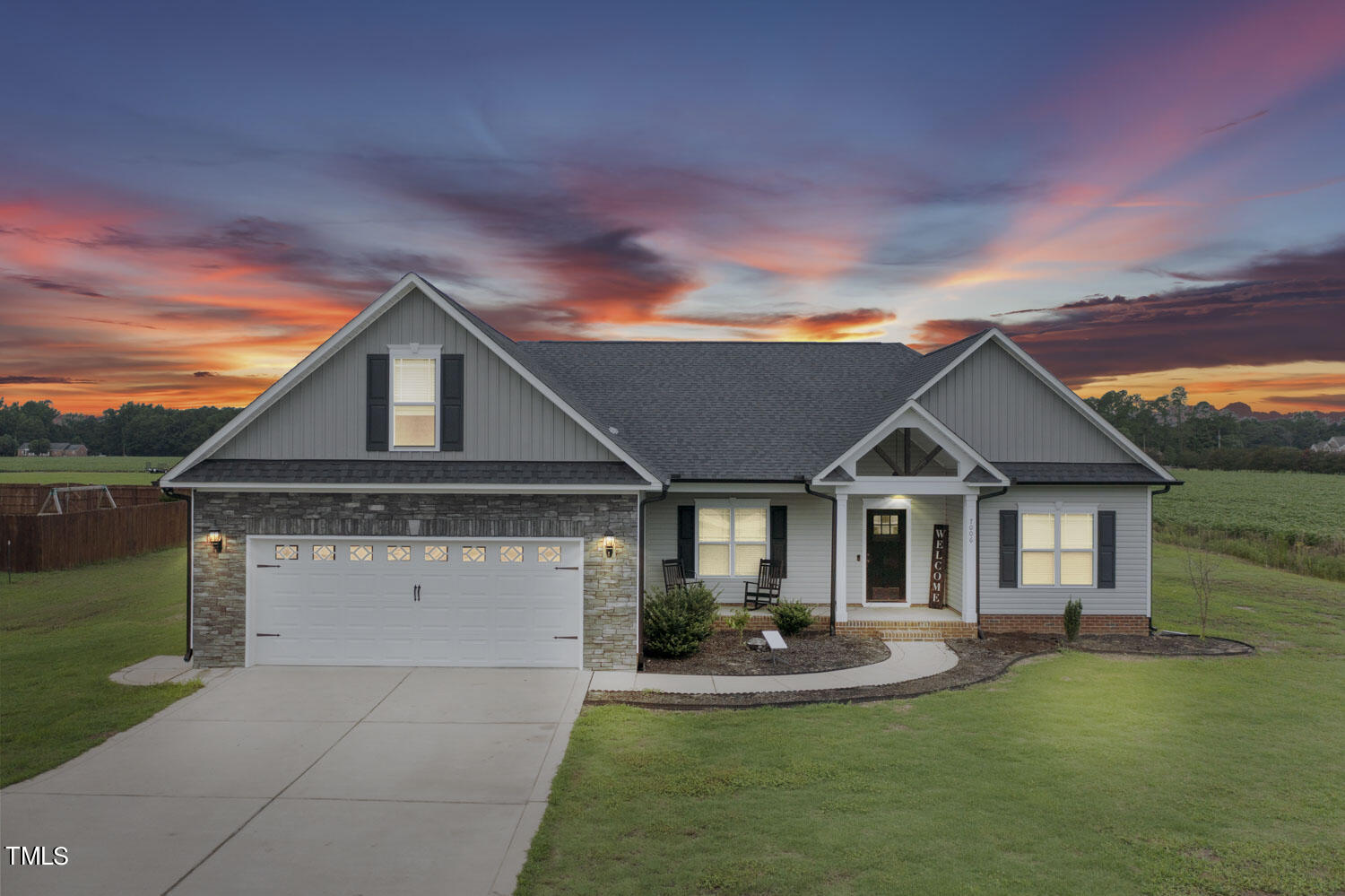 a front view of house with yard patio and green space