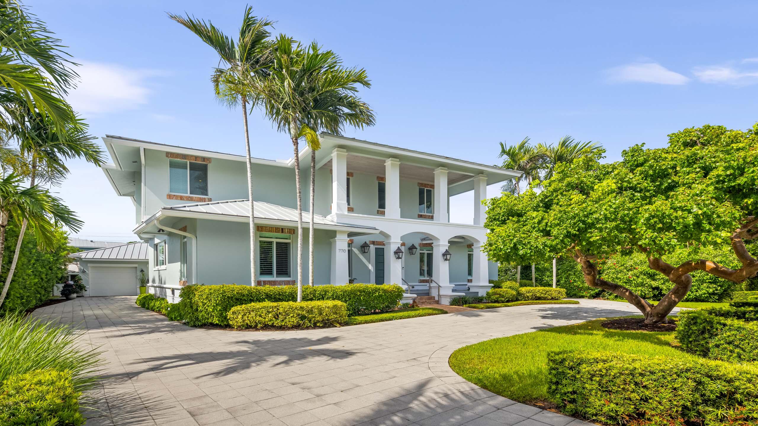 a front view of a house with yard and green space