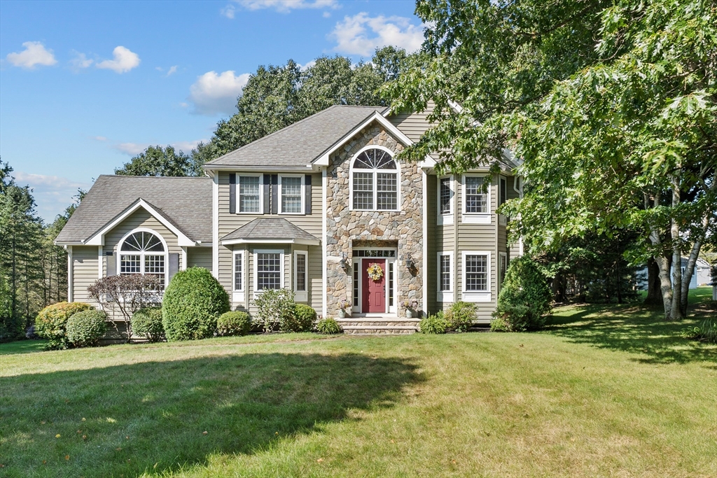 a front view of a house with a yard