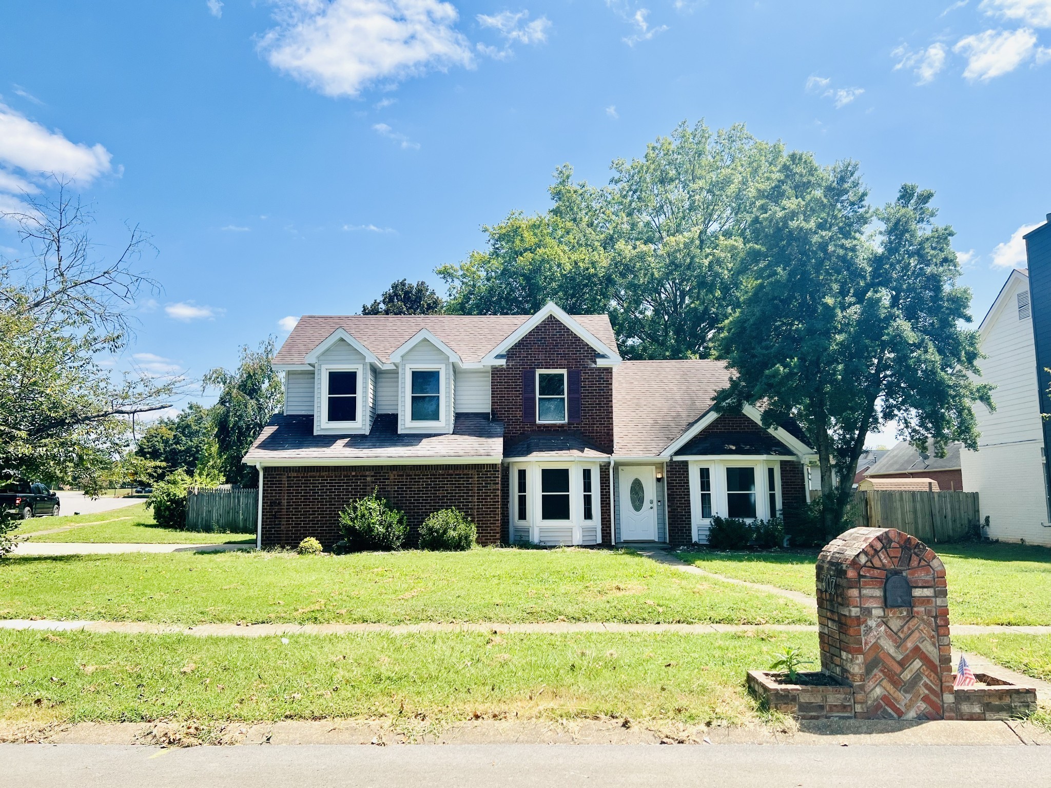 a front view of a house with a yard