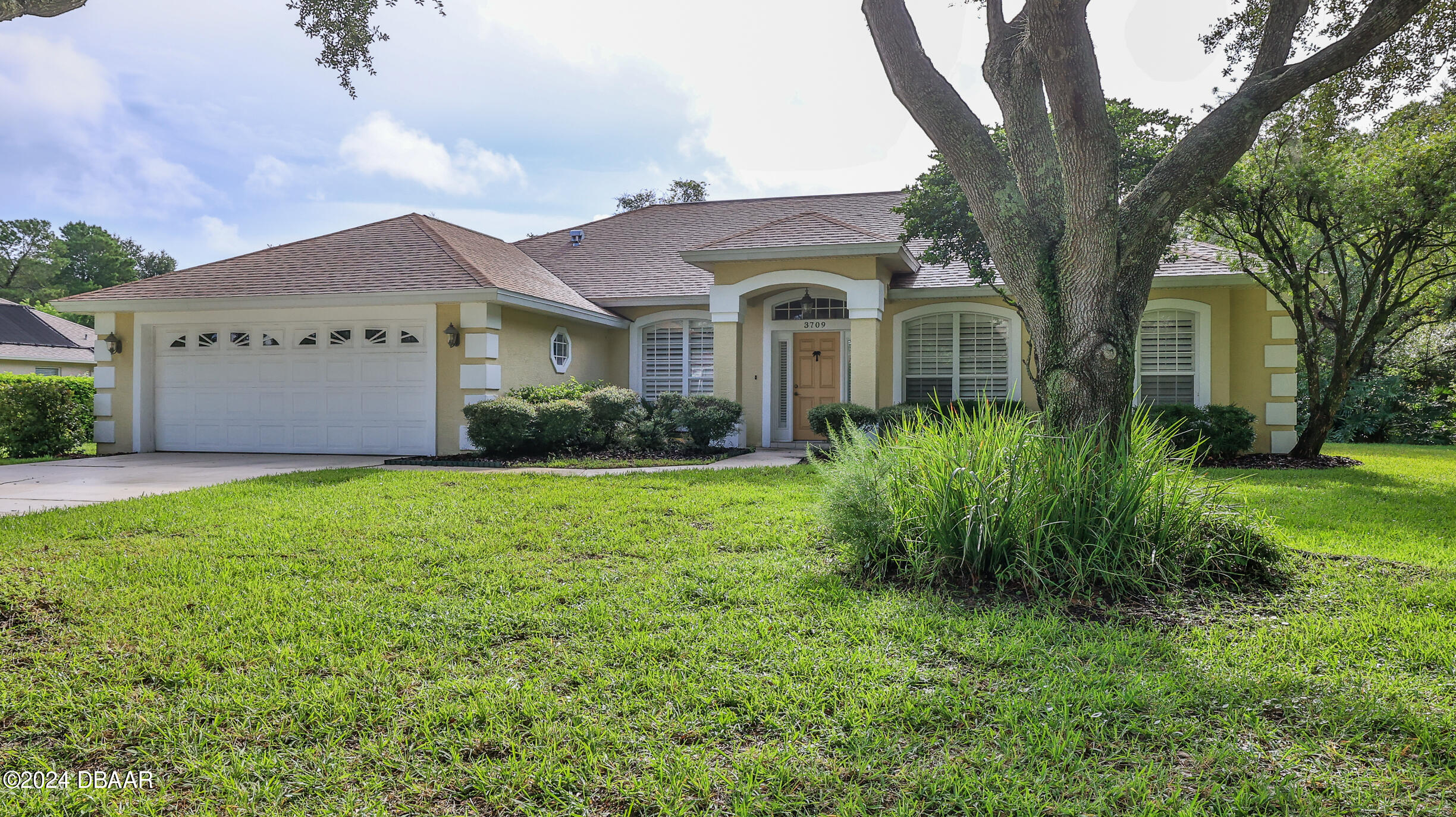 a front view of a house with garden