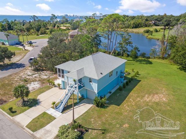 an aerial view of a house with yard swimming pool and outdoor seating