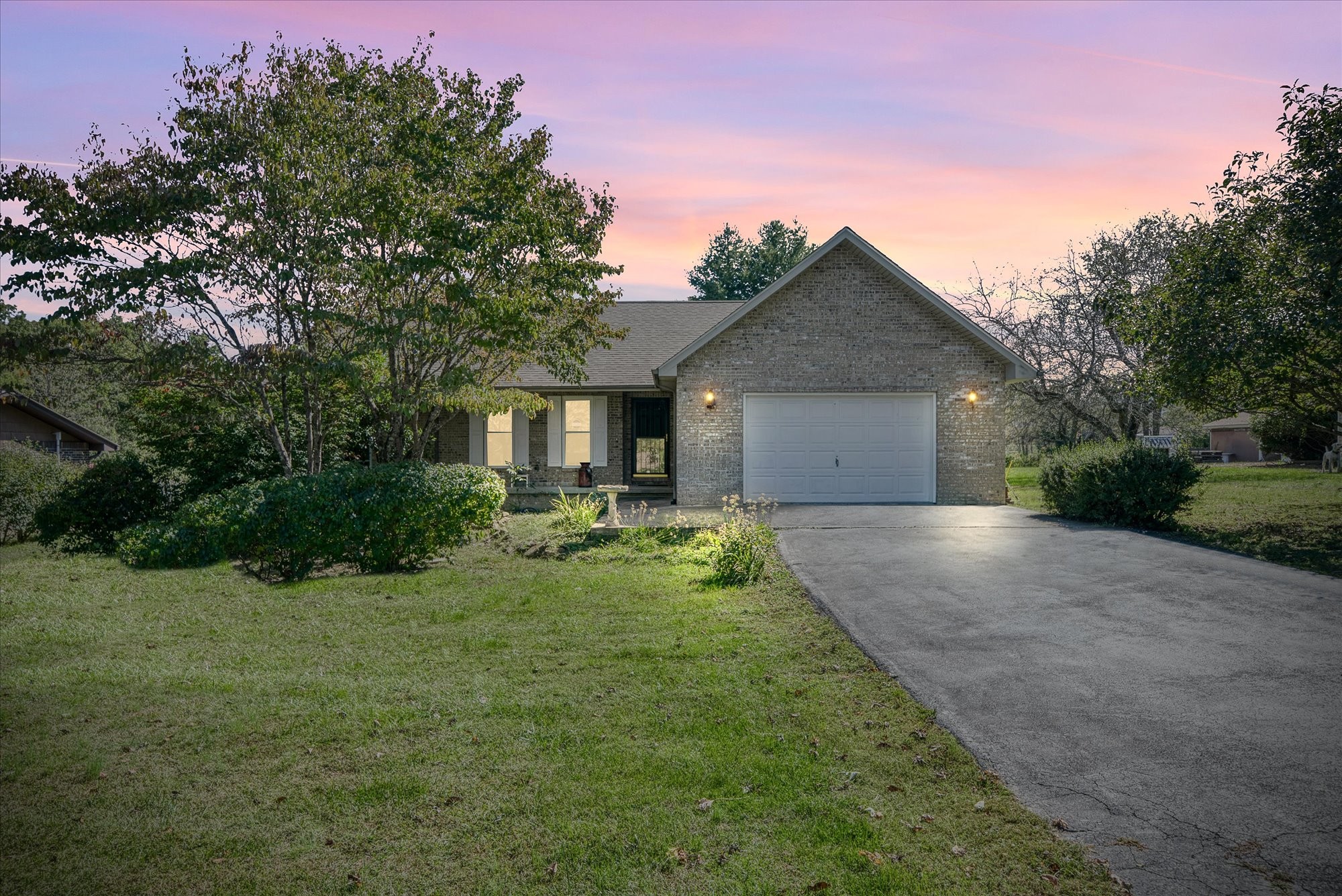 a front view of house with yard and green space