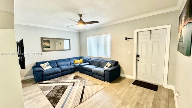 a living room with furniture and a ceiling fan