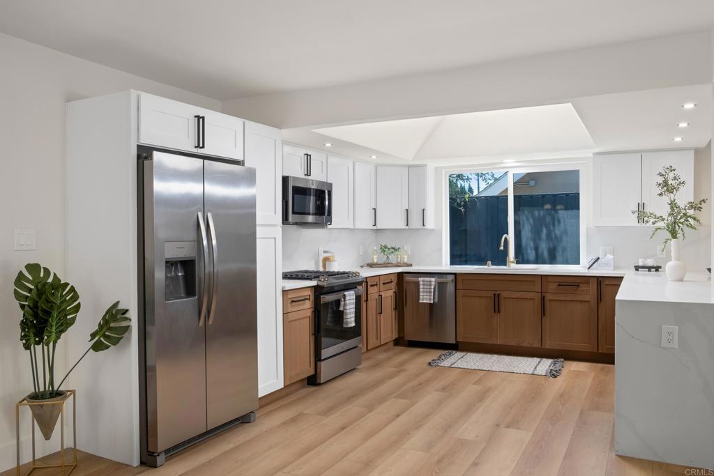 a kitchen with a refrigerator and a sink