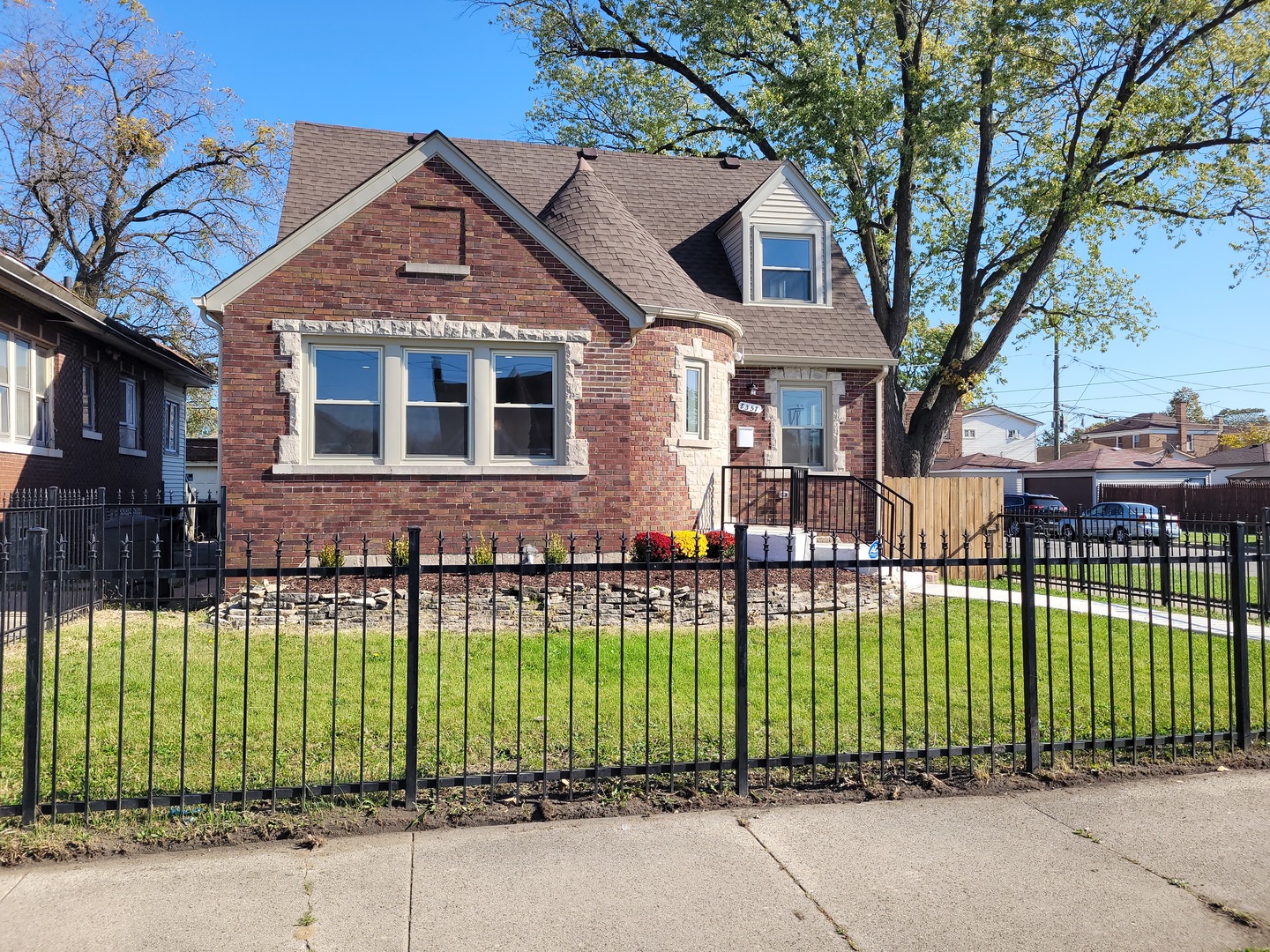 a front view of a house with a garden