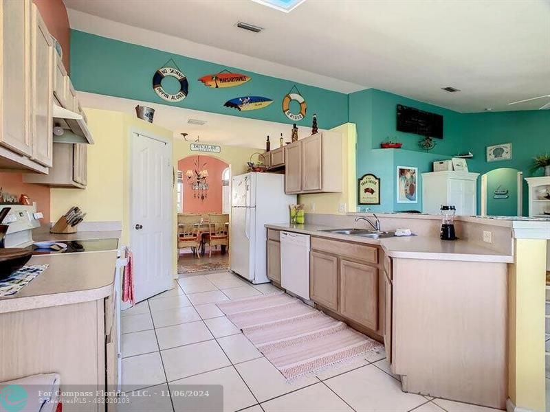 a kitchen with a sink a stove and cabinets