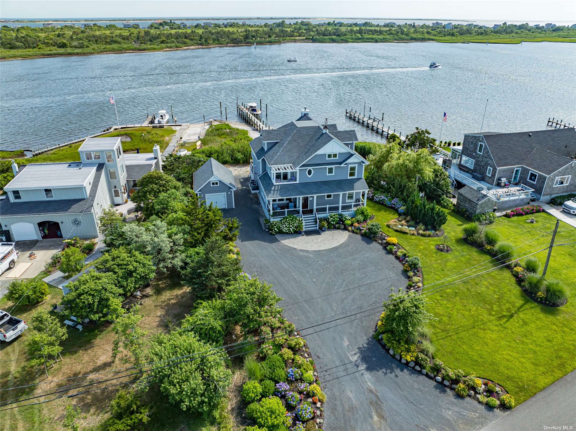 an aerial view of a house with a yard and lake view