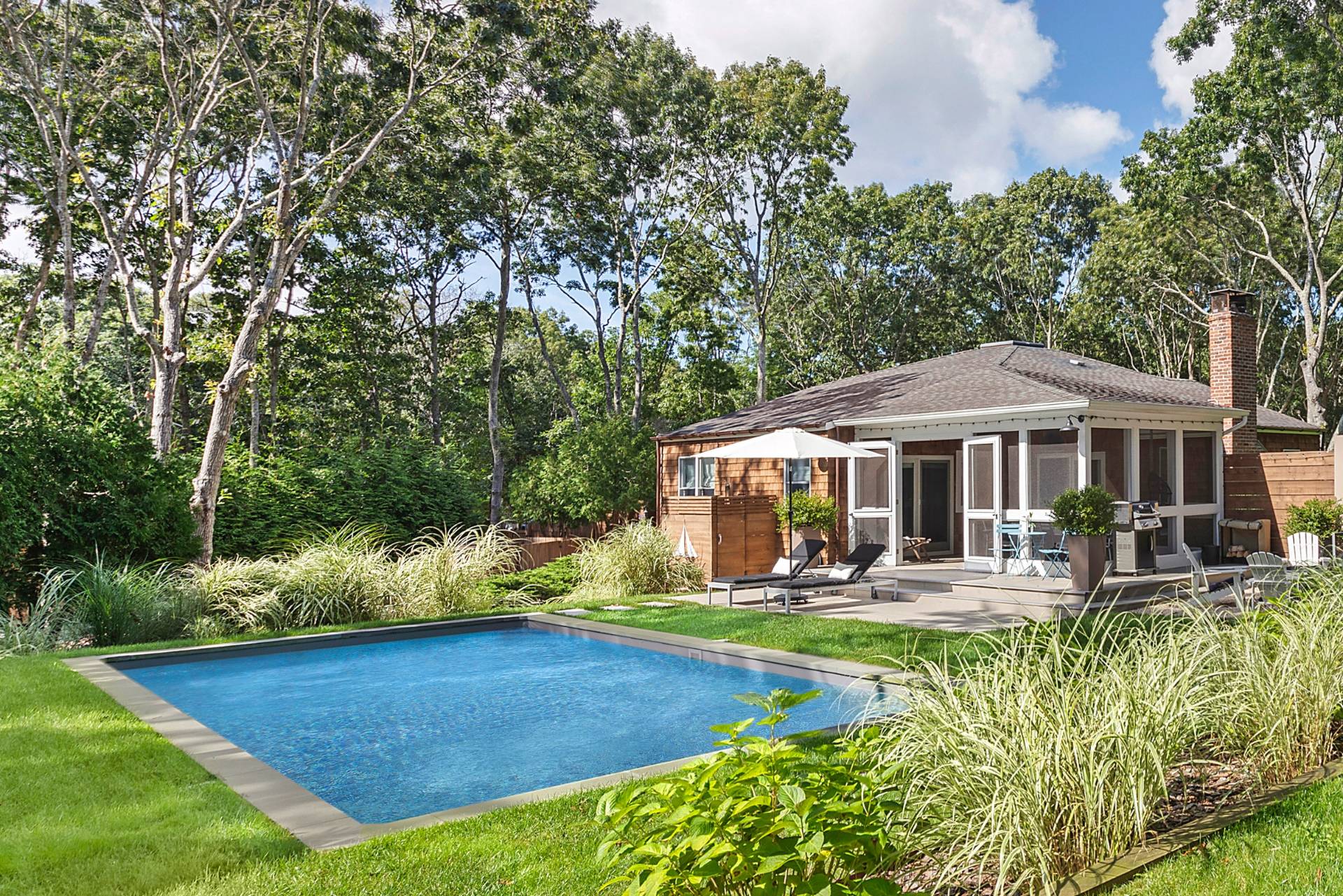 a front view of a house with swimming pool yard patio and swimming pool