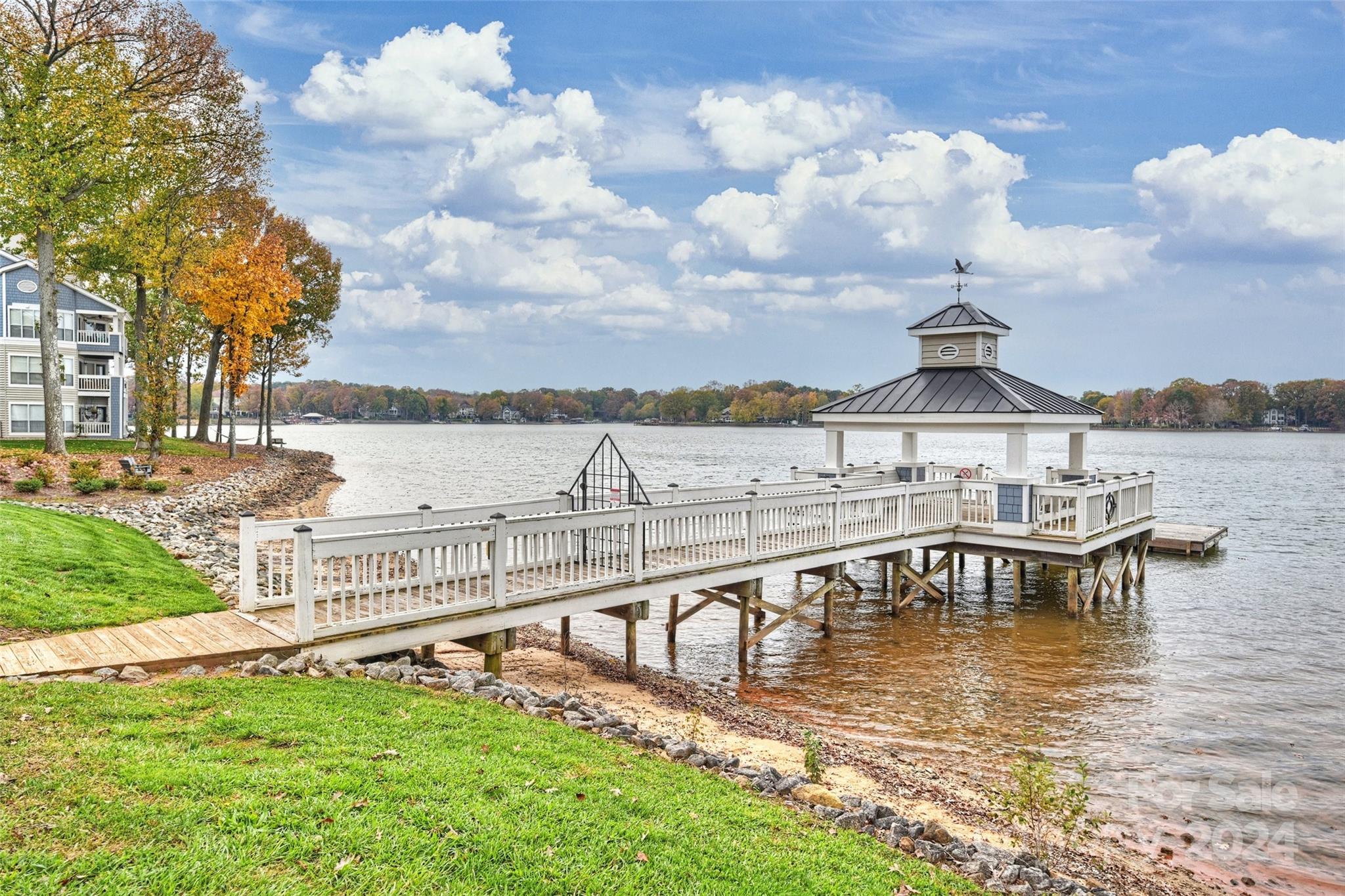 a view of a lake with a bench next to a lake