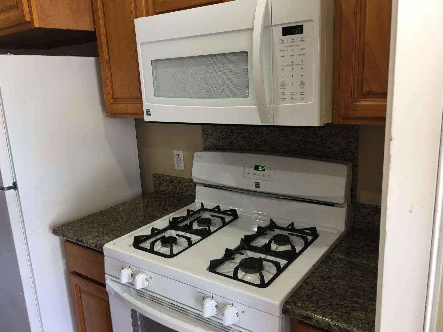 a stove top oven sitting inside of a kitchen