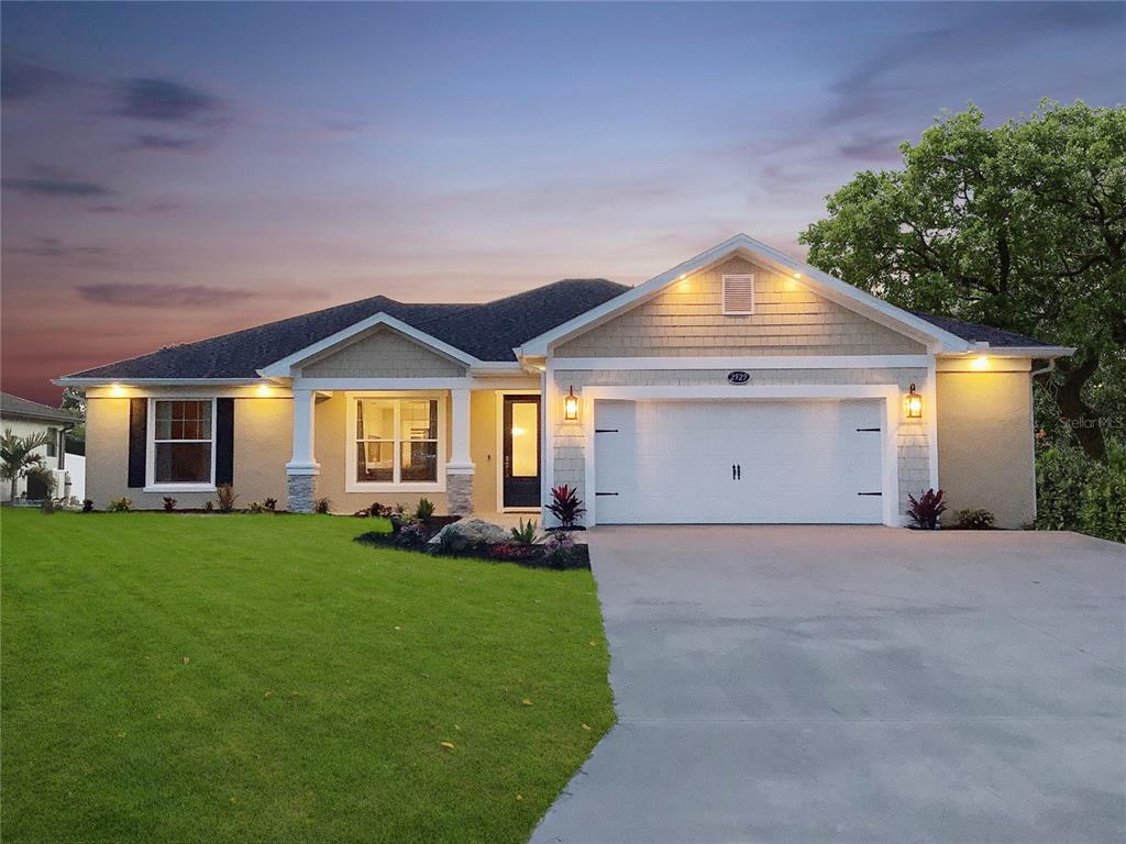 a front view of a house with a yard and porch