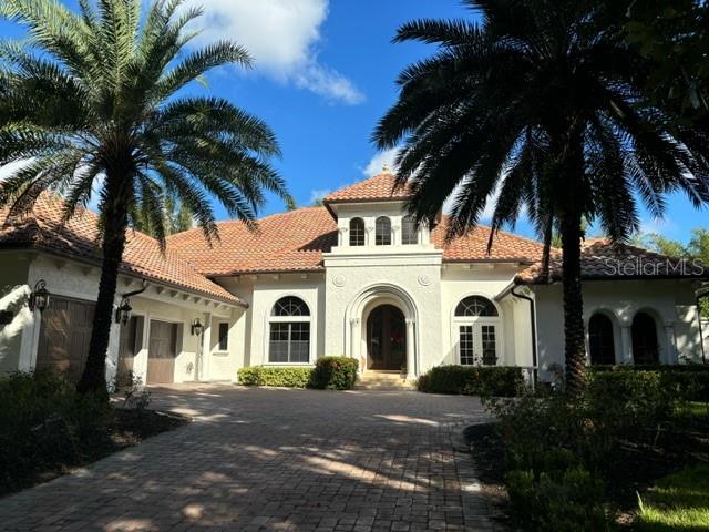 a white house with palm tree in front of it