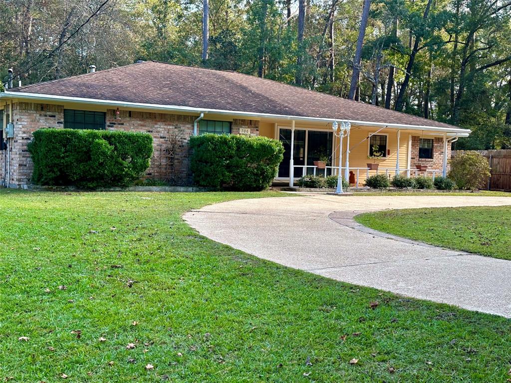 a front view of a house with a garden and plants