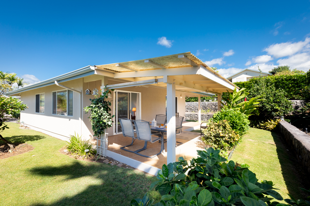 a view of a house with backyard sitting area and garden