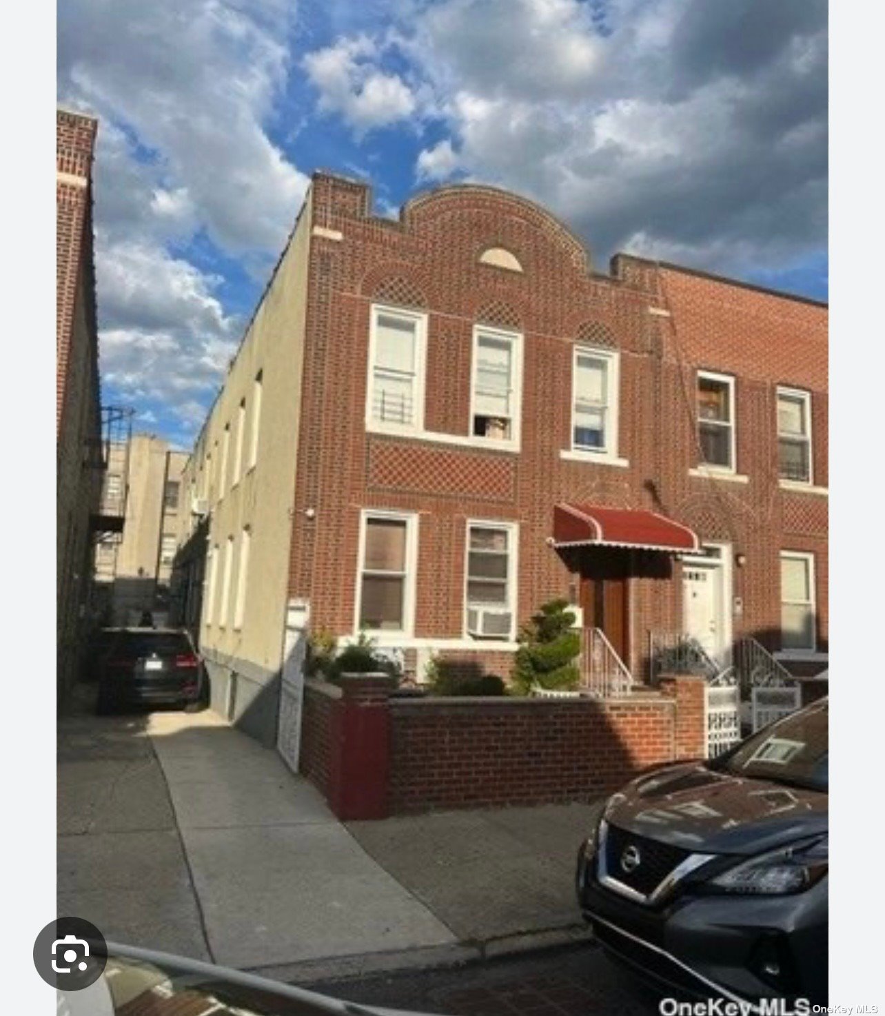 a view of a brick house with many windows