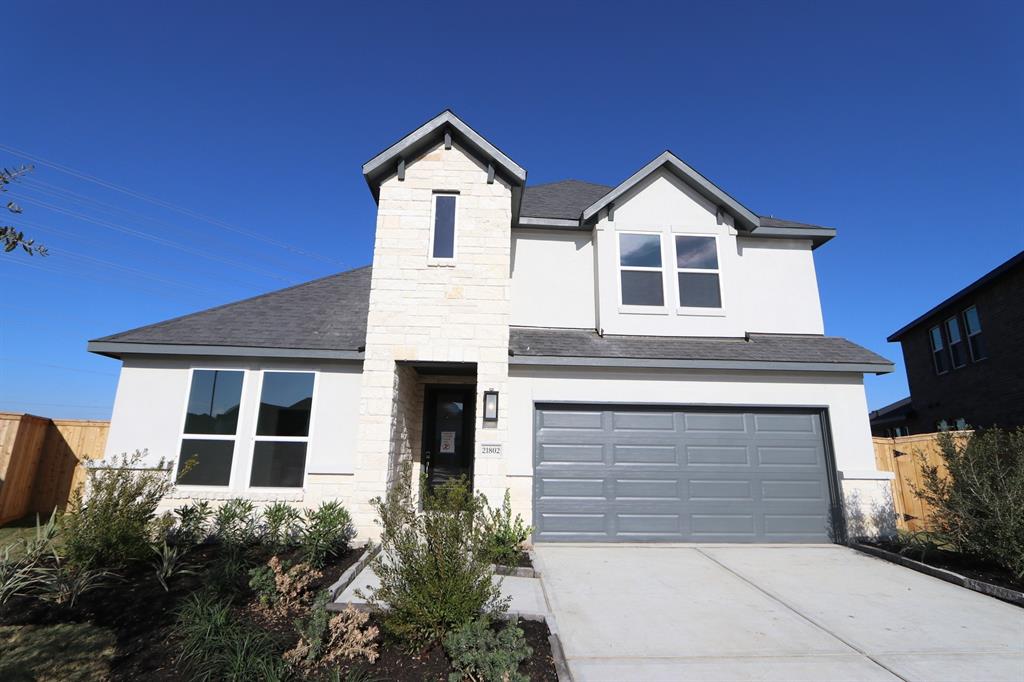 a front view of a house with garage